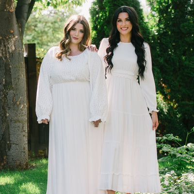 Two ladies wearing LDS temple dresses standing side by side