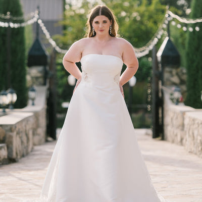 Bride standing with her hands on her hips wearing a wedding dress Utah