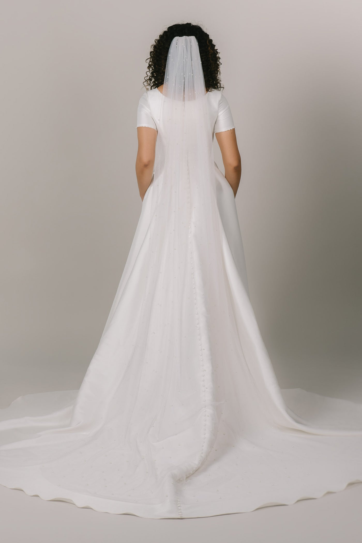 This is a veil with pearl details and it is chapel length.