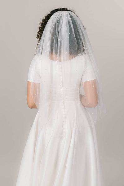 This is a fingertip length veil with pearl details scattered across the veil.