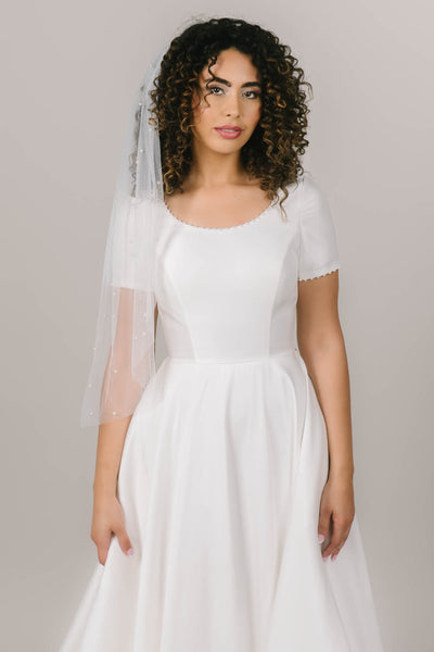 This is a fingertip length pearl veil perfect for a bride wanting to add pearl details.