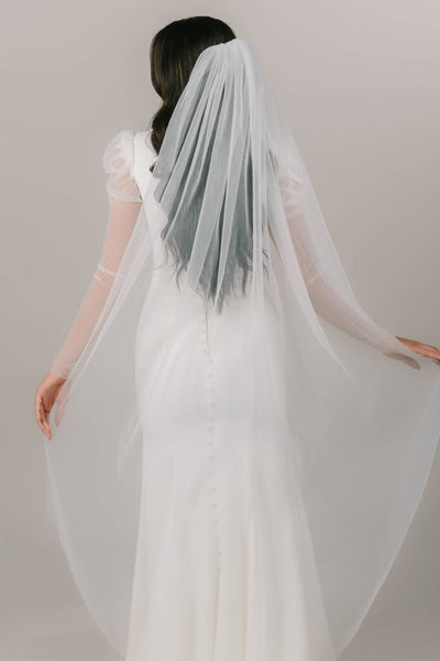 This is a back shot of a model wearing a pleated tulle veil.