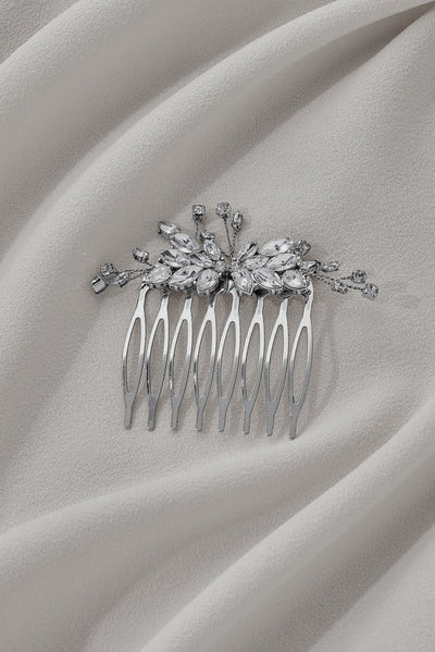 A basic shot of a silver, bejeweled hairpiece with floral details and big gems.