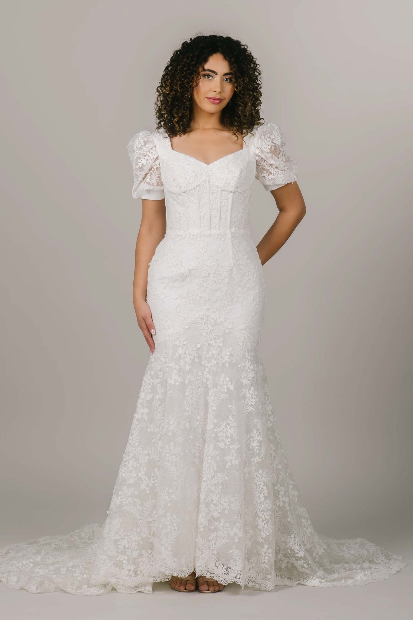 This is a front shot of a modest wedding dress with a sweetheart neckline and boning along the bodice.