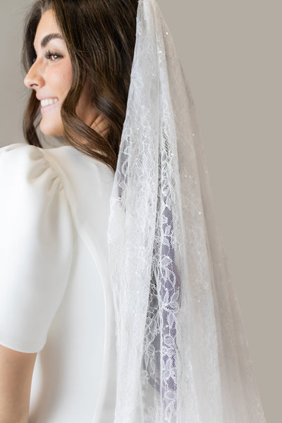 This is a close shot of a lace wedding veil for a bride wanting a cathedral long veil.