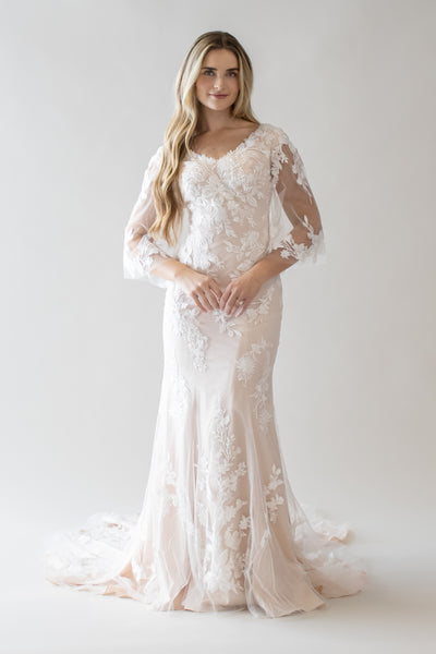 This is a modest wedding gown with a sorbet lining and lace floral flutter sleeves.