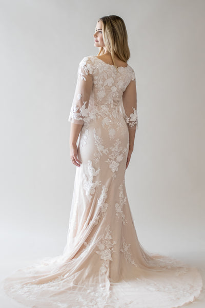This is a modest wedding dress with a sorbet lining and a fitted silhouette with lace floral details.