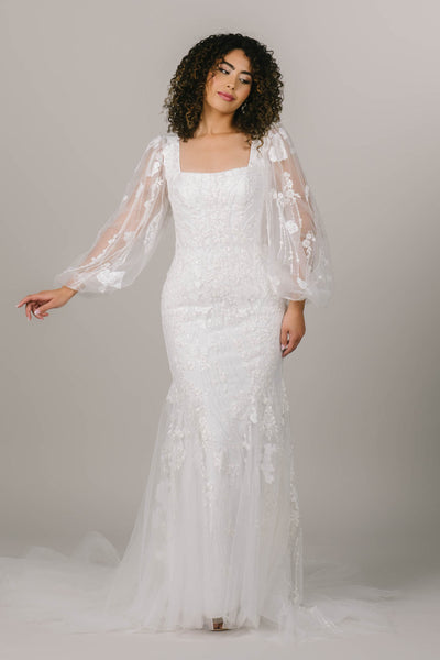 This is an alternate shot of a modest wedding dress with lace balloon sleeves and a square neckline.