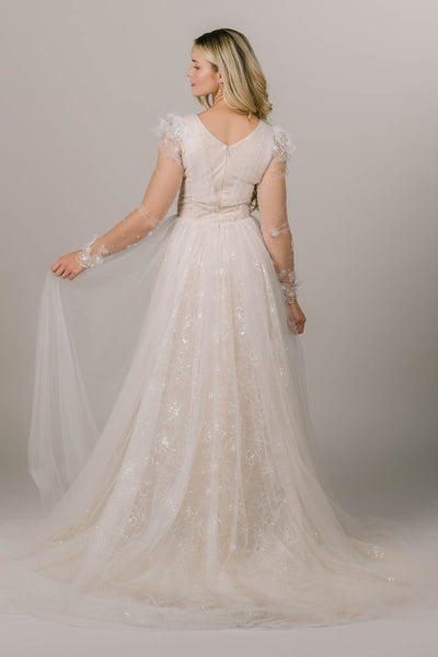 This is the back of a modest wedding gown with an a-line silhouette and sparkly  lace.