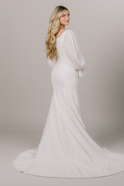 This is a modest wedding gown with buttons all  along the back.