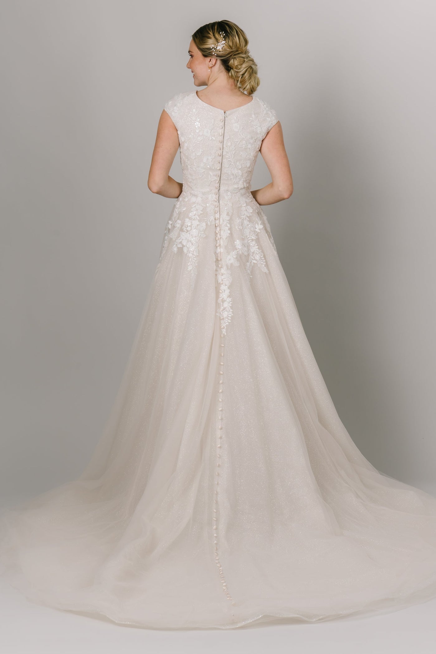 This Modest Wedding Dress features a round neckline, and lace appliques that trickle down the skirt with a glitter lining. - Modest Clothing - Modest Wedding Dresses - Modest Dresses - LatterDayBride