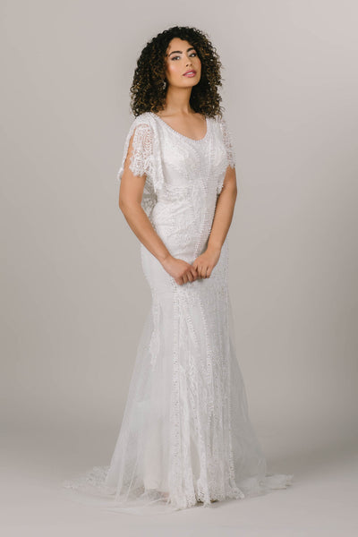 This is an alternate front shot of a modest wedding dress with fun flutter sleeves and intricate beading details