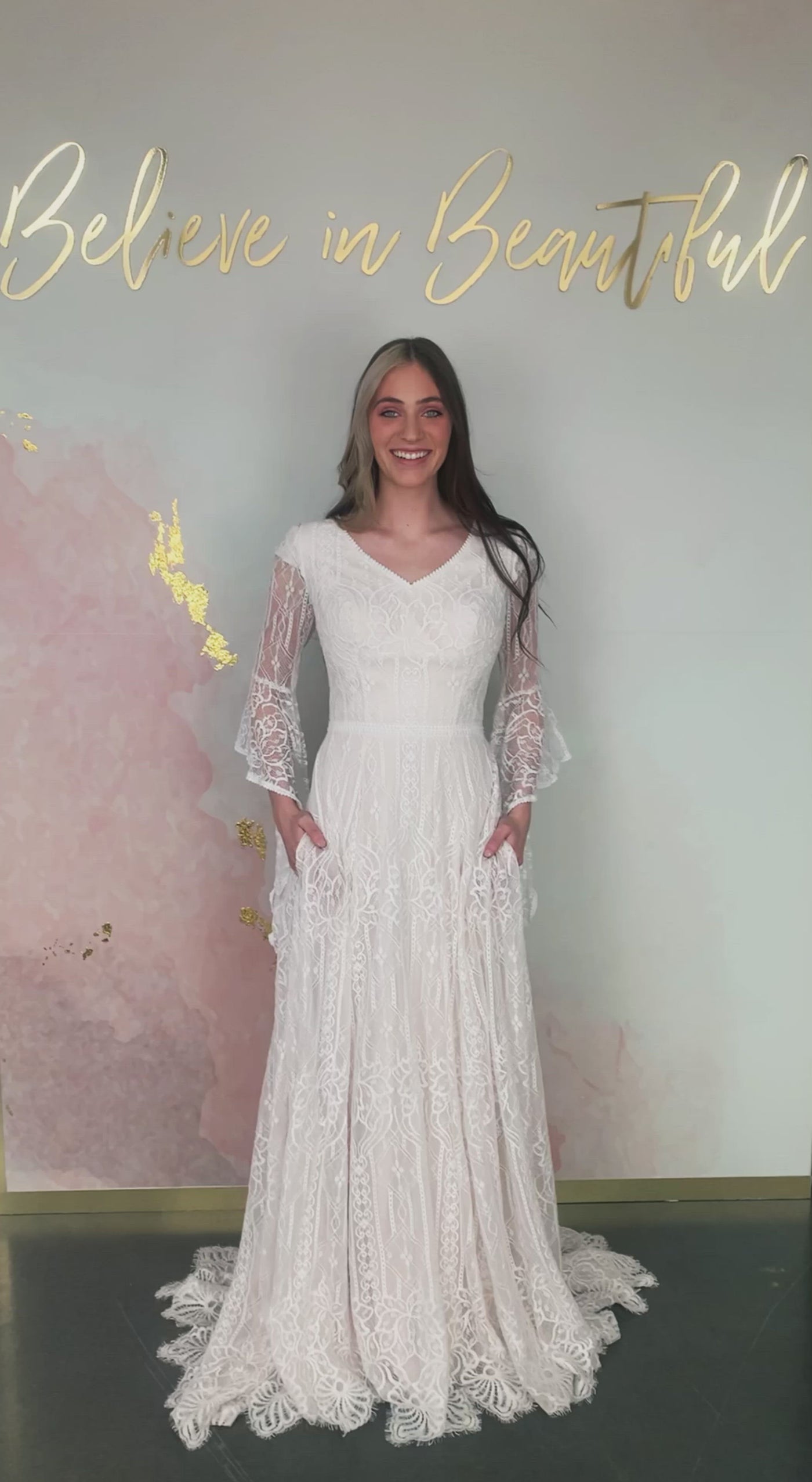 A video featuring our Arwen wedding dress with its full lace A-line skirt, whimsical bell sleeves, and eyelash lace detailing at the hem.