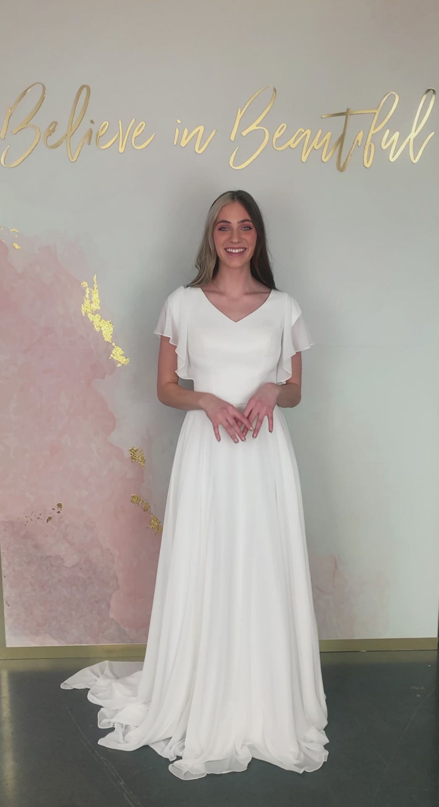 A video featuring our Brienne wedding dress and its flowy, boho chiffon skirt with matching flutter sleeves.