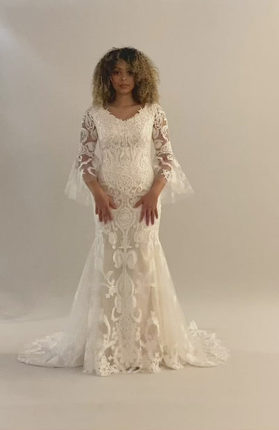 Modest wedding dress video of Illusion lace pattern with a V-neck and bell sleeves and a medium train. 