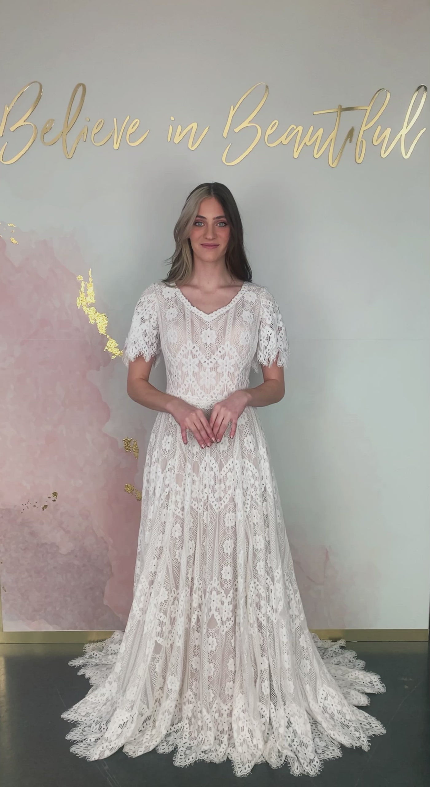 A video featuring our Calabria wedding dress and its lace flutter sleeves, full A-line lace fit, and floral lace pattern.