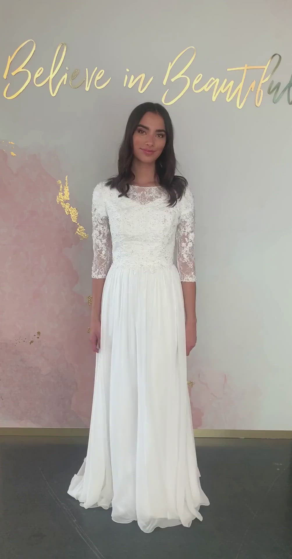 A video featuring our Quentin wedding dress and it's beaded applique bodice, illusion neckline, sheer sleeves, and flowy chiffon skirt.