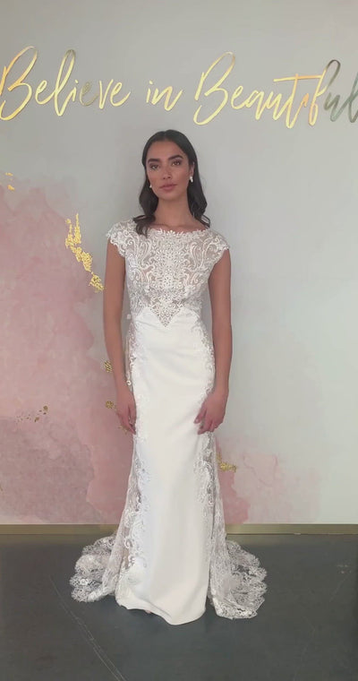 A video featuring our Brielle wedding dress and its sophisticated fit and flare silhouette, illusion lace detailing, and chic neckline.