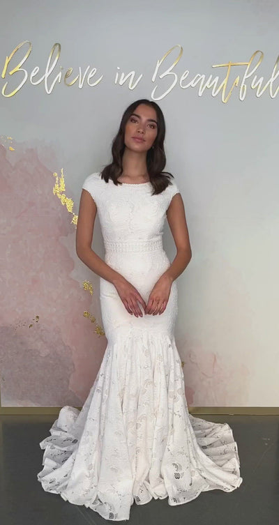 A video featuring our Janessa wedding dress and its gorgeous trumpet silhouette with cap sleeves and all-over lace detailing.