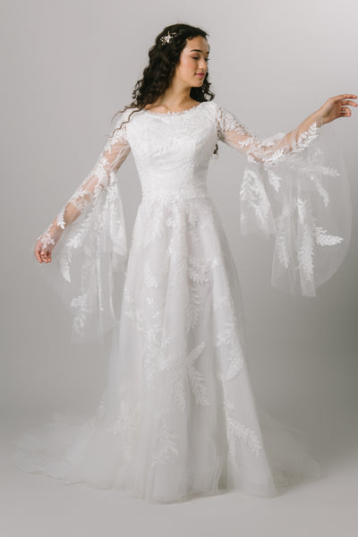  A-line modest wedding dress with bell sleeves.