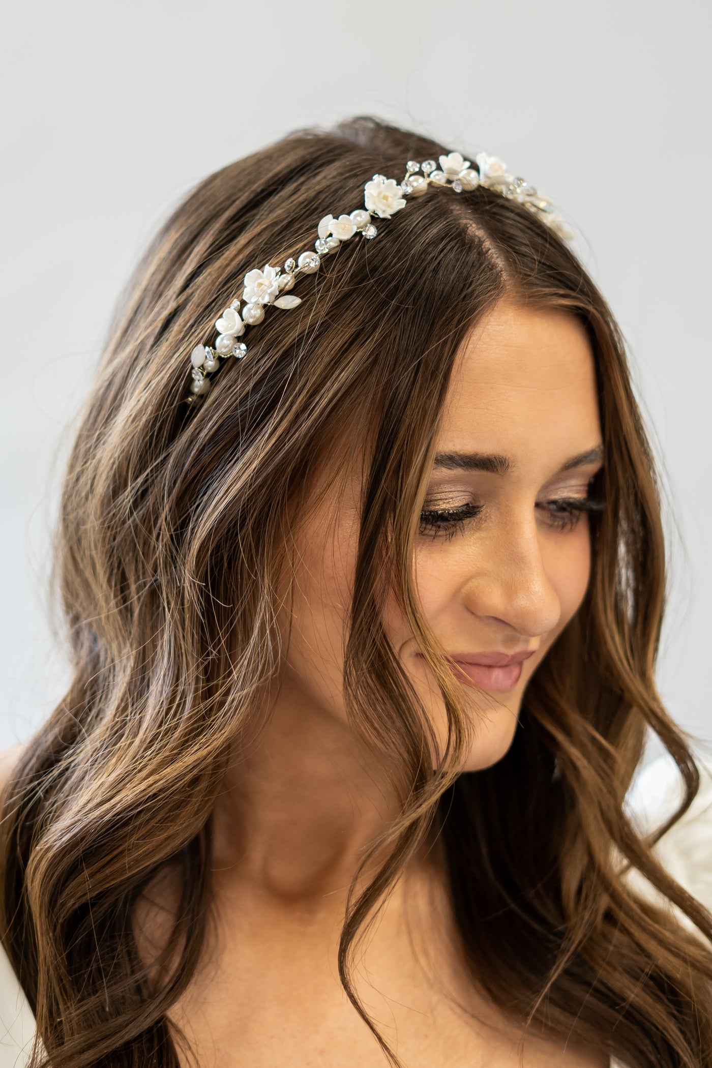A headpiece with pearl, crystal, and floral accents to perfectly compliments a wedding dress