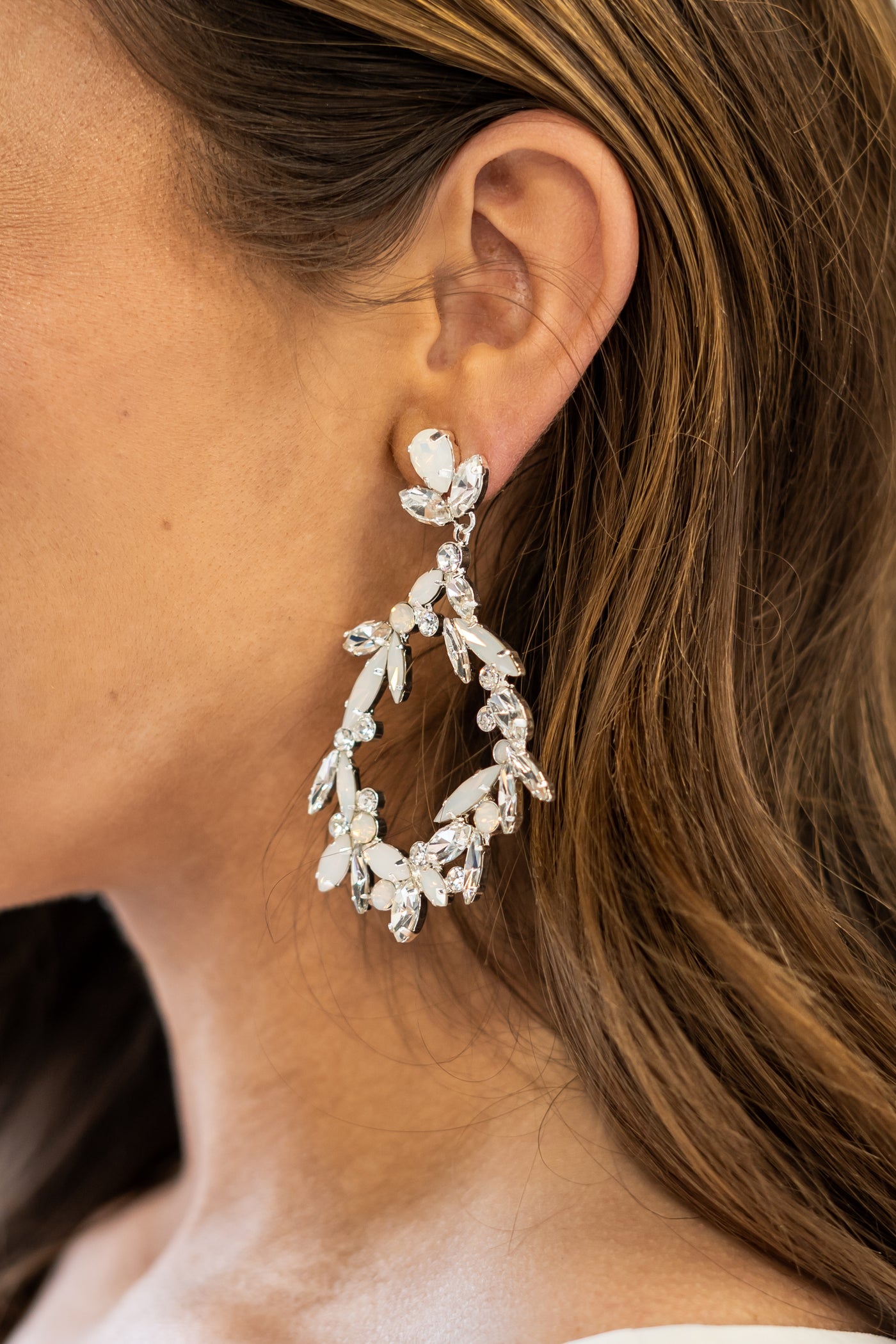 A side shot of this crystal and opal silver plated earring is the perfect statement piece to complete your bridal look