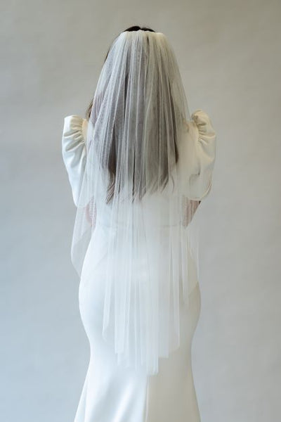 A back shot of a fingertip length veil with soft English tool perfect to accessorize any bridal gown.
