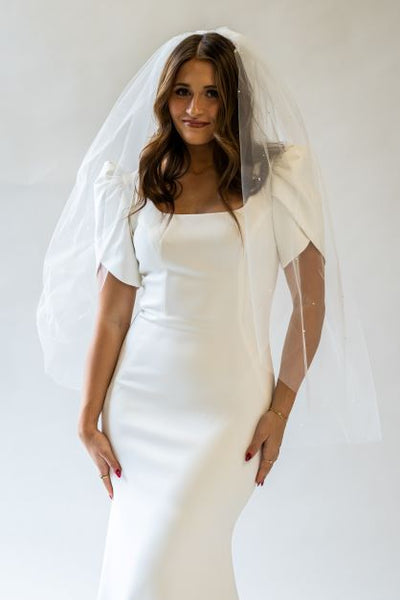 A portrait shot of a fingertip length veil with scattered pearls for the perfect way to accessorize any wedding dress.