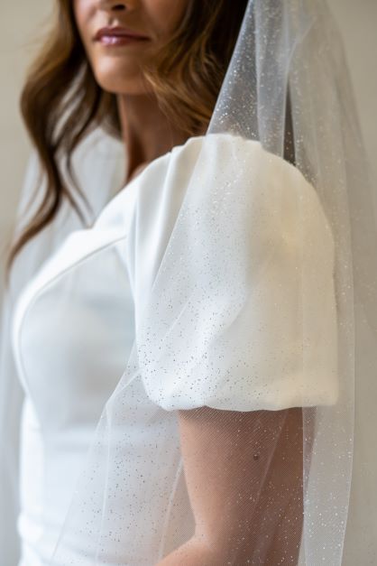 A close up side profile shot of a cathedral length bridal veil with sparkles concentrated throughout. Perfect for adding a beautiful shimmer over your bridal gown.
