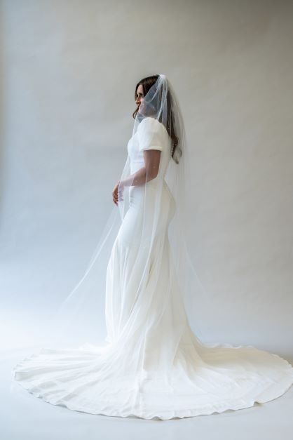A portrait side angle of a floor length, simple, scattered pearl veil perfect for any bride.