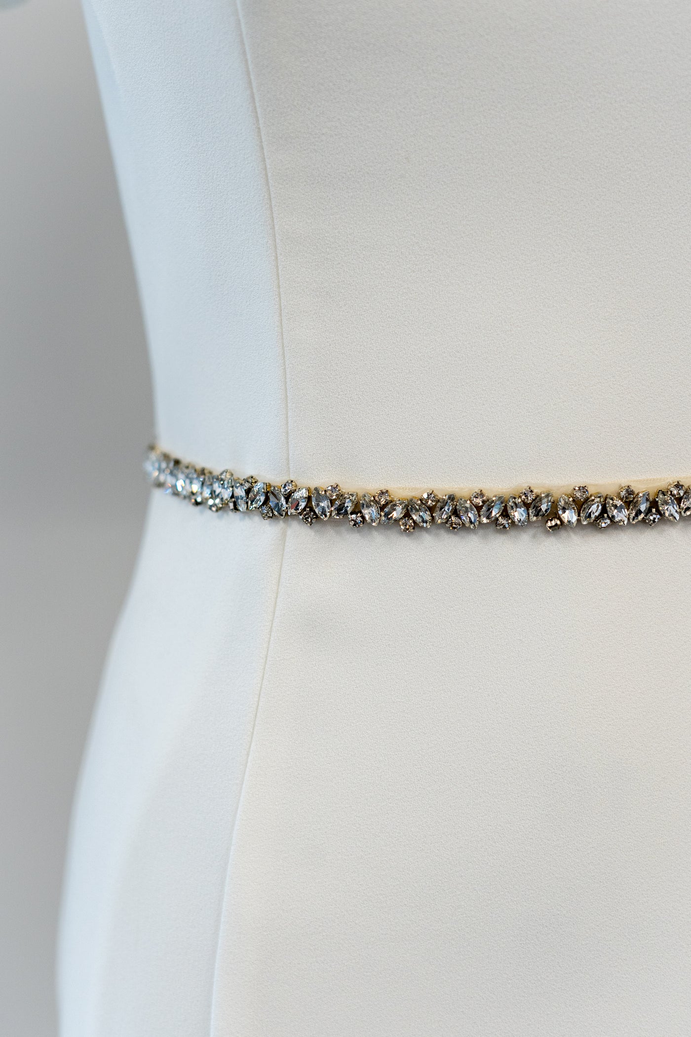 A beautifully studded belt with different sizes of diamonds in alternating directions to accessorize a modest wedding dress.