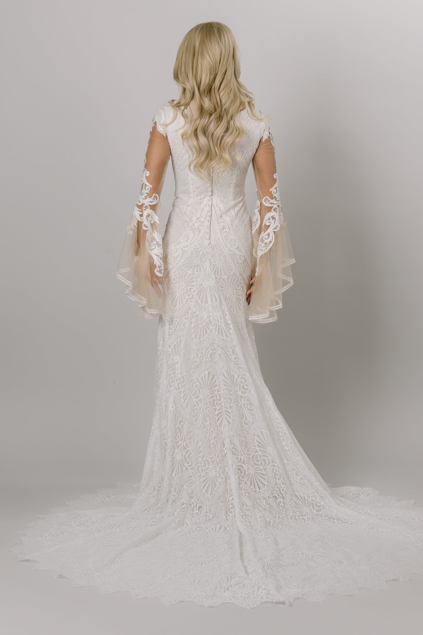 Back of fitted lace modest wedding dress. 