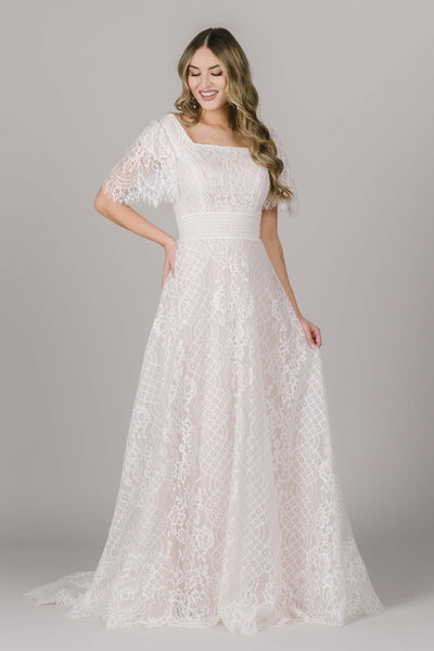Another shot of the front of this beautiful modest wedding dress in Utah with a very unique lace. The flutter sleeves are some of our favs! Come shop this dress in store!