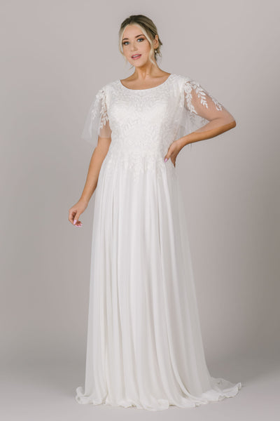 Another shot of this beautiful lace modest wedding dress with flutter sleeves. The skirt is made out of a flowy chiffon material that lays so effortlessly.