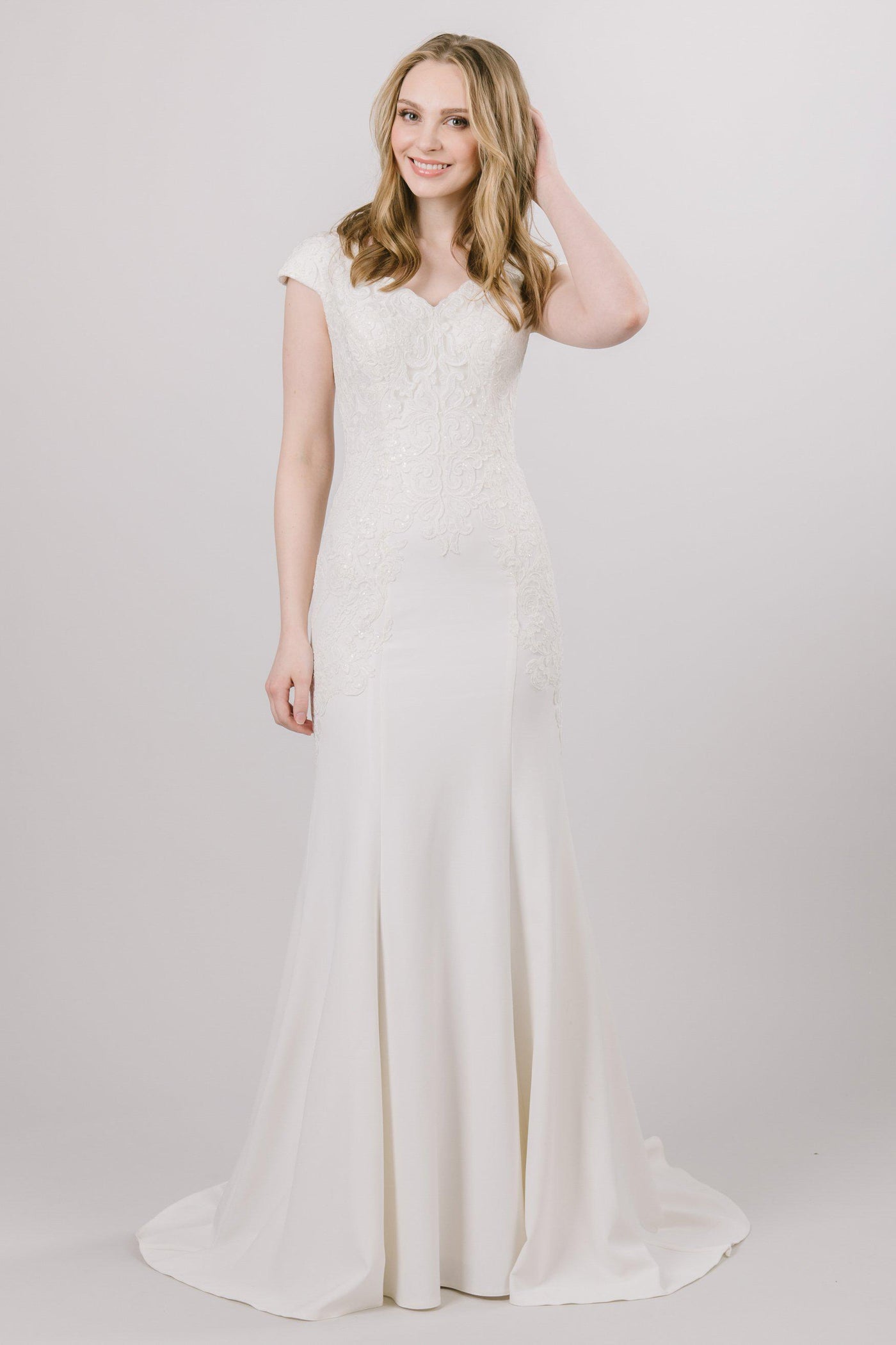 Soft fit and flare dress with beading on the top that moves down the modest wedding dress at salt lake city bridal shop