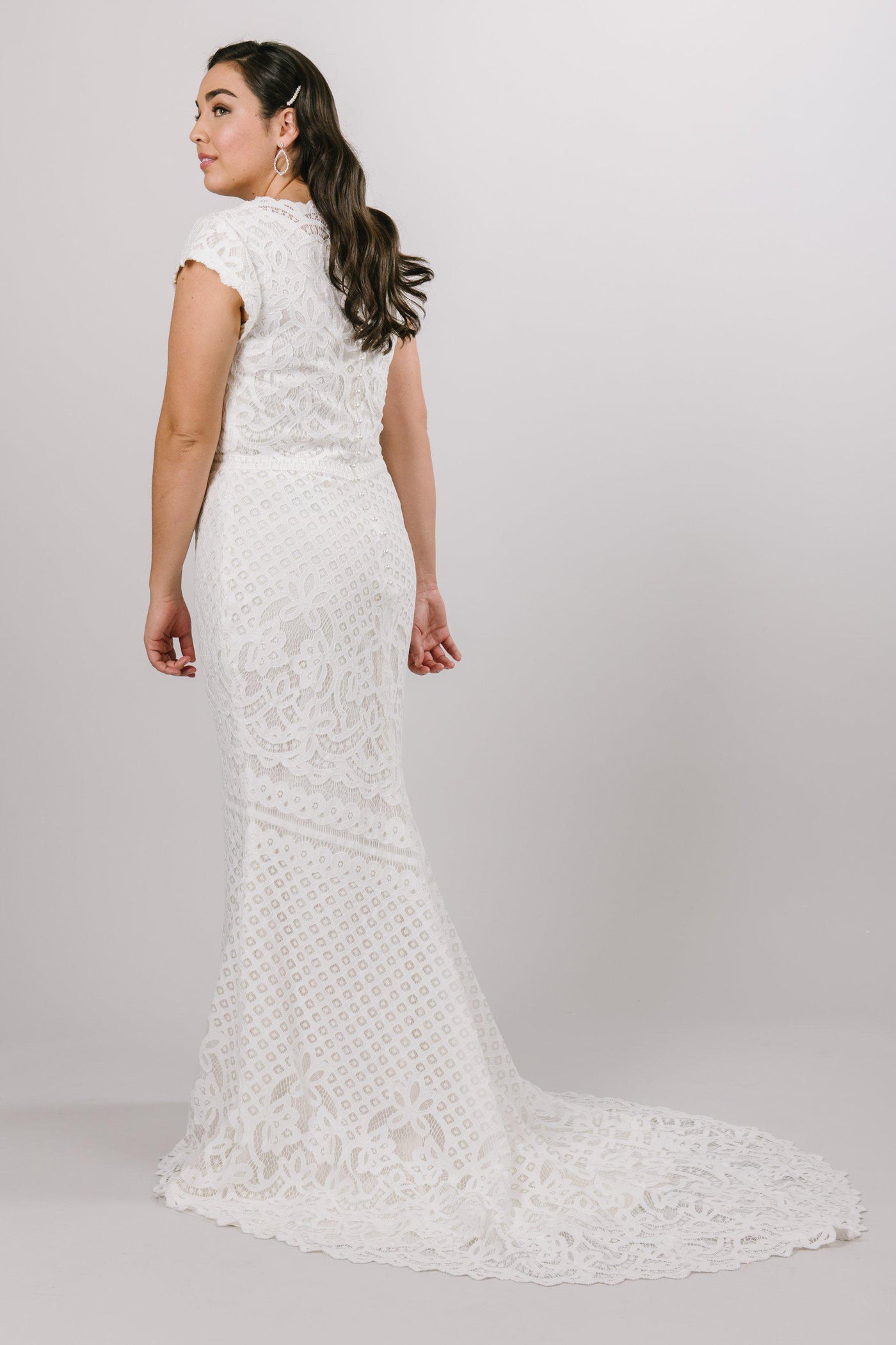 Boat neckline with delicate scalloped sleeves, style Luciana, is part of the Wedding Collection of LatterDayBride, a Salt Lake City bridal shop.