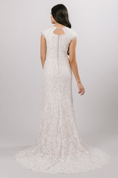 Modest laced wedding dress with capped sleeves featuring a soft aline look from bridal shop in Salt Lake City Utah