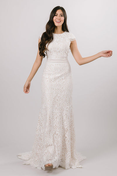 Modest laced wedding dress with capped sleeves featuring a soft aline look from bridal shop in Salt Lake City Utah 