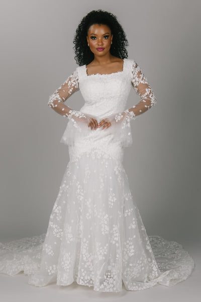 Bell sleeve modest wedding dress. This dress has a square neckline and mermaid fit. It has gorgeous leaf and vine 3D lace. this dress would be stunning for a fall, winter, or spring modest wedding dress bride. 