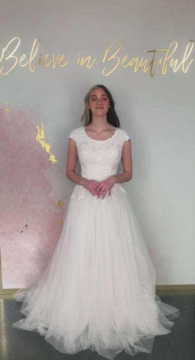 A video featuring our Amelia wedding dress with its soft A-line and floral lace detailing that trails into the skirt.  