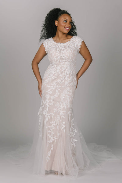 Front view of modest wedding dress with vine-link lace. It has a scoop neckline and tulle skirt. It has a nude underlay. Gorgeous for any modest wedding dress bride.