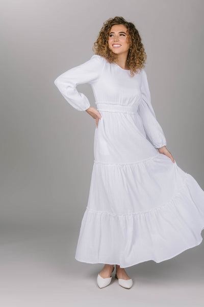 Front view of temple dress with tiered skirt. The cinched waist and puffed sleeves make this dress comfortable and stylish. Temple dress is perfect for your special moments. 