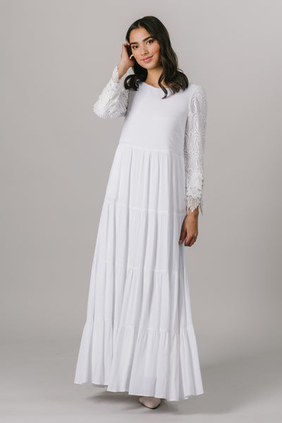 This LDS temple dress features fully lined lace sleeves and a multiples tiers through the skirt. It includes two pockets.