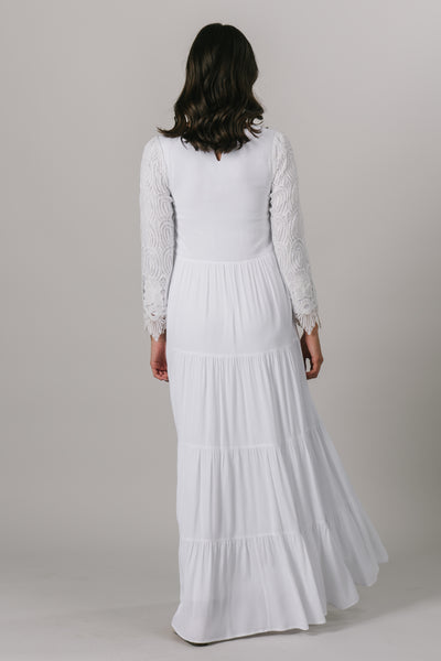 This LDS temple dress features fully lined lace sleeves and a multiples tiers through the skirt. It includes two pockets. From an LDS bridal shop in downtown Salt Lake City.