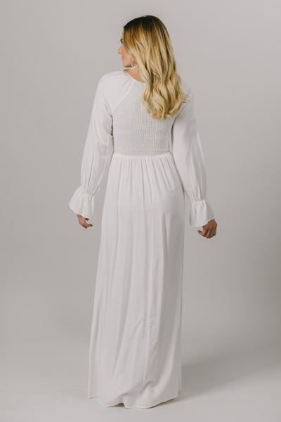 This LDS temple dress features a shirred, textured bodice and fun bell sleeves. It includes two pockets. From a bridal shop in downtown Salt Lake City.