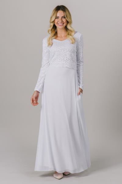 This LDS temple dress features a fully lined, loose lace bodice with a flattering waistband. It includes two pockets and a zipper close.