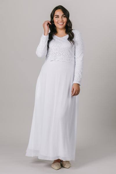 This plus size temple dress features a fully lined, loose lace bodice with a flattering waistband. It includes two pockets and a zipper close.