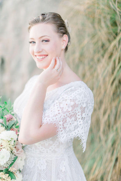 Real bride wearing a boho lace modest wedding dress with flutter sleeves. This modest wedding dress is from LatterDayBride, a bridal shop located in downtown Salt Lake City, Utah.
