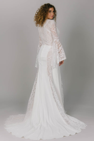 Back view of modest wedding dress with bell sleeves. This boho styled dress has dedicate sheet lace and a v-neckline. It is a fitted dress and perfect for that modest bride.