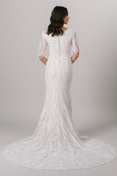 This fitted modest wedding dress has a lovely v-neck and a unique lace pattern that creates the most darling illusion half sleeves. Available in Sand/Ivory (pictured) and Almond/Champagne/Ivory.  Style Love: Gorgeous lace train!